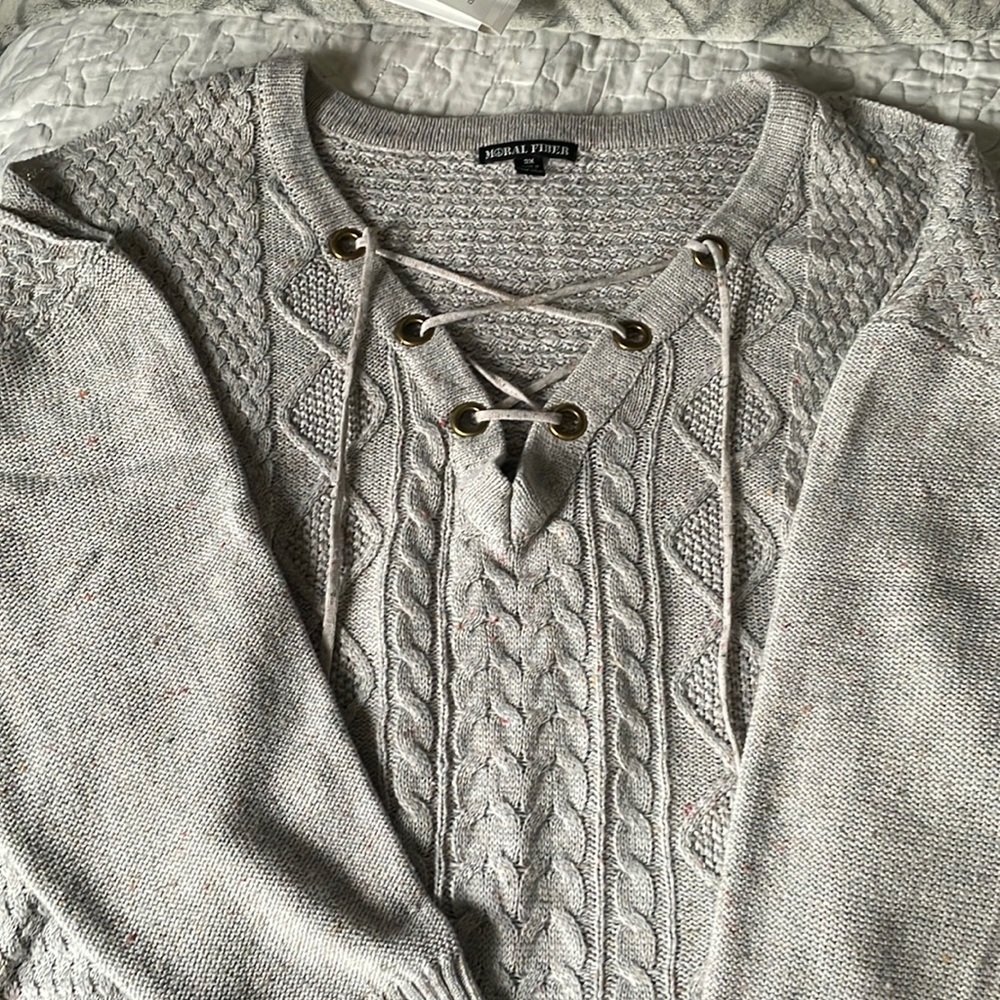 Woman’s grey multi colored lace up sweater